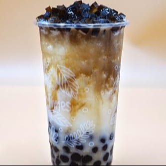 I10. Iced Milk Drink W/ Caramel, Dark Brick, & Honey Boba.